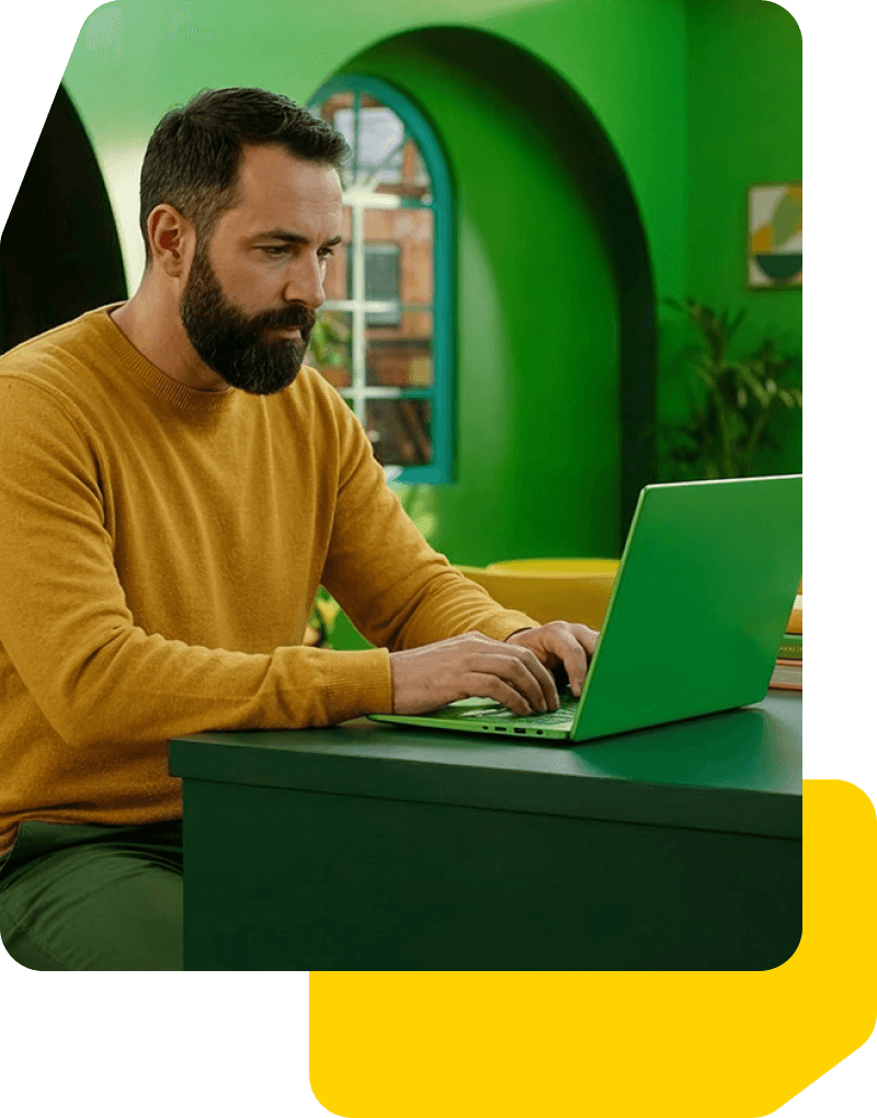 Man typing on laptop computer.
