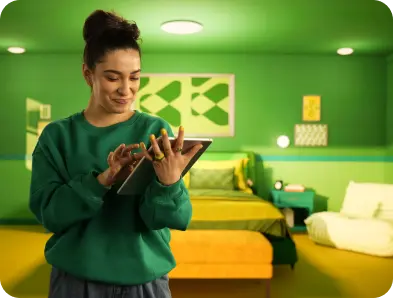 Smiling woman typing on tablet PC.